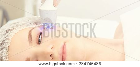 Light Infrared Therapy. Cosmetology Head Procedure. Beauty Woman Face. Cosmetic Salon Device. Facial