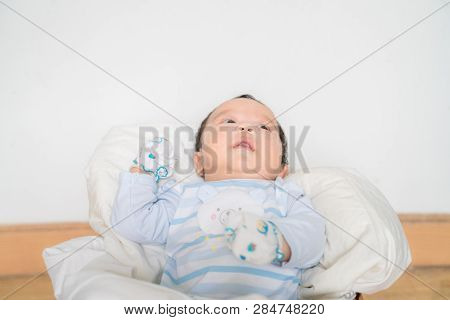 Infant Baby Lying On Blanket In Wood Baket On White Background