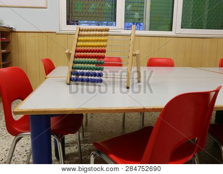 Interior Of A School Classroom With Wooden Abacus Above The Table To Teach Children To Count
