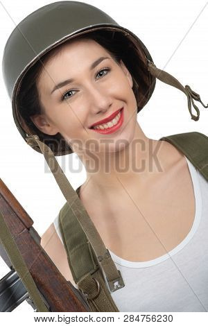 Pretty Young Woman Dressed In Wwii Military Uniform With A Helmet And Rifle