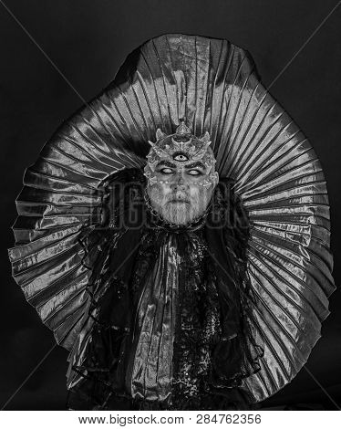 Man With Third Eye, Thorns Or Warts. Demon With Golden Collar On Black Background. Alien, Demon, Sor