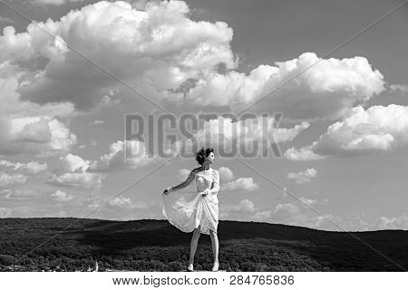 Girl On Sunny Blue Sky Background In Summer. Girl In White Summer Dress Pose On Blue Sky Abckground