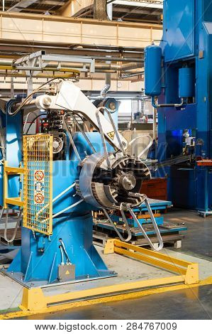 Cold Rolled Steel Coil On Decoiler Of Machine In Metalwork Manufacturing. Modern Equipment For Sheet