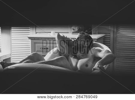 Sexy Macho Relax Naked In Bathtub Seen In Eyehole, Curiosity. Bodycare, Wellness, Pleasure, Relax. B