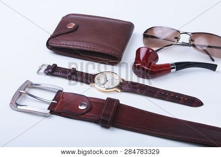 Mens Accessories For Business And Rekreation. Leather Belt, Wallet, Watch And Smoking Pipe On White 
