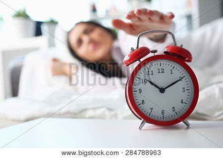 Sleepy Young Woman Portrait With One Opened Eye Trying Kill Alarm Clock. Early Wake Up Not Getting E
