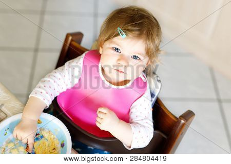 Adorable Baby Girl Eating From Spoon Mashed Vegetables And Puree. Food, Child, Feeding And People Co