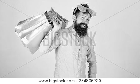 Man Bearded Hipster Wear Sunglasses Hold Bunch Shopping Bags. How To Get Ready For Your Next Vacatio