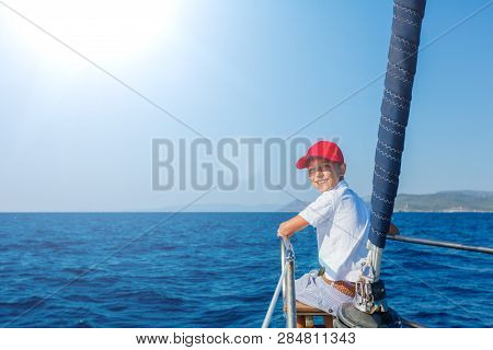Little Boy On Board Of Sailing Yacht On Summer Cruise. Travel Adventure, Yachting With Child On Fami