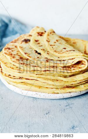 Norwegian Potato Pancakes Lefse On A Light Background With Cheese And Greens. Traditional Scandinavi