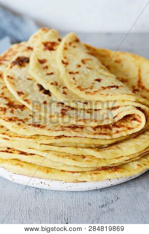 Norwegian Potato Pancakes Lefse On A Light Background With Cheese And Greens. Traditional Scandinavi