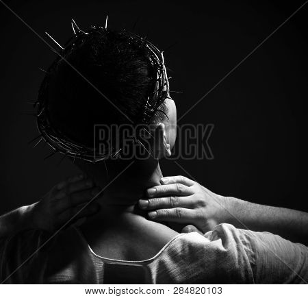 Crown Of Thorns On The Head Of Martyr Who Stands With Back To Us Looks Up To The Sky And Holds His H