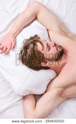 How Much Sleep You Actually Need. Bearded Man Sleeping Face Relaxing On Pillow. Man Handsome Guy Lay