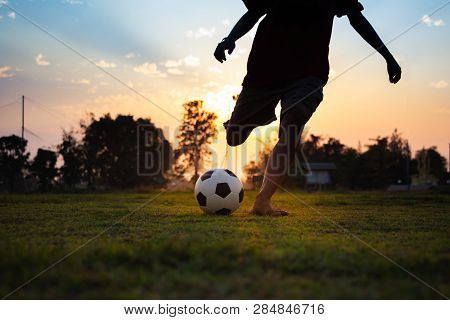 Silhouette Action Sport Outdoors Of A Group Of Kids Having Fun Playing Soccer Football For Exercise 