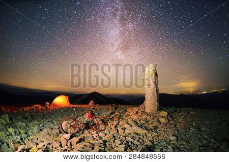 Bike On A Stone Pillar Tops At Night