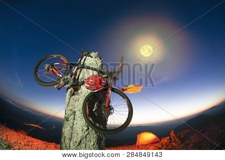 Bike On A Stone Pillar Tops At Night
