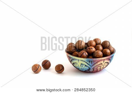 Macadamia Nuts In Bowl On White Background, Copy Space