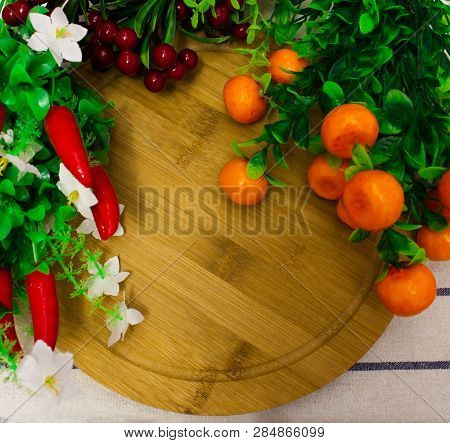 Red Round Berries, Fresh Ripe Juicy Orange Tangerines With Green Leaves, On A Round Wooden Board, Ho