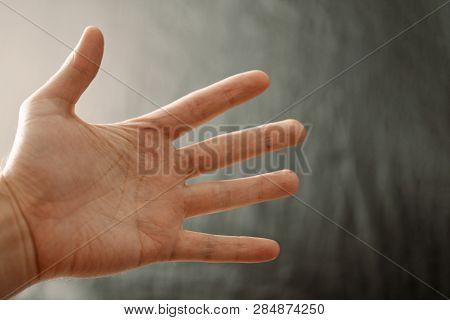 Adult Hand With Raynaud's Syndrome - Phenomenon. Close Up Hand With Fingers On Dark Background With 