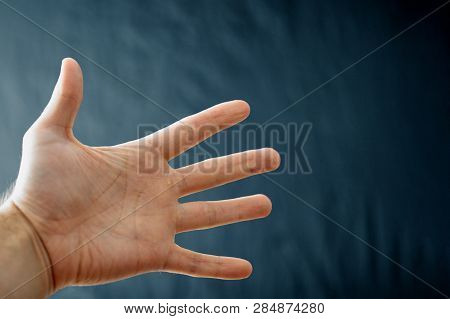 Adult Hand With Raynaud's Syndrome - Phenomenon. Close Up Hand With Fingers On Dark Background With 