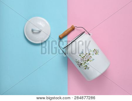 Enameled Milk Can On Blue Pink Pastel Background. Top View