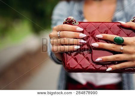 Trendy Woman With Beautiful Manicure Holding Red Handbag.