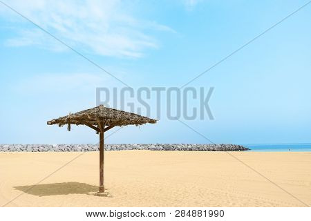 Thatched Parasol On An Empty Gold Beach. Al Mamzar, Dubai, Emirates, Jul.2018