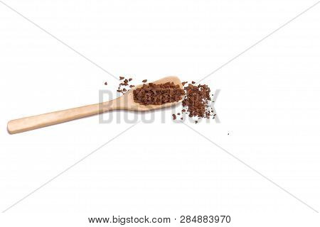 Instant Coffee Powder On A Wooden Spoon And The Ground On White Isolated Background