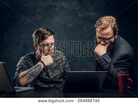 Two Programmers Are Thinking Hard, Trying To Find A Solution To The Problem In Office Against The Ba