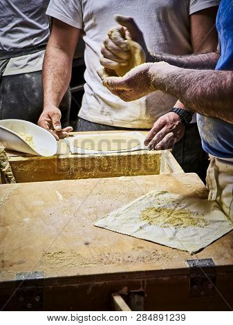 Cooks Making Tortillas On A Wooden Rustic Table.