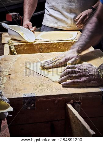 Cooks Making Tortillas On A Wooden Rustic Table.