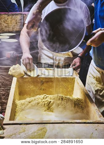 Cooks Making Dough For Tortillas On A Kneading Trough.