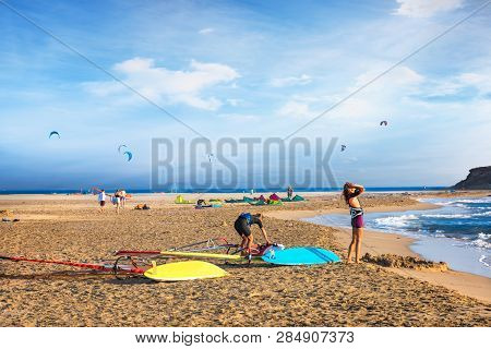 Two Girls Getting Ready To Windsurf On Prasonisi Beach (rhodes, Greece)