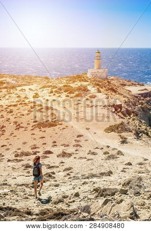 Girl Walking To White Lighthouse In Prasonisi National Park (rhodes, Greece)