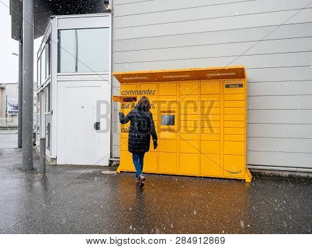 Strasbourg, France - Feb 8, 2018: Young Woman Using Amazon Locker The Self-service Parcel Delivery S