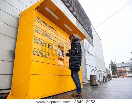 Strasbourg, France - Feb 8, 2018: Young Woman Using Amazon Locker The Self-service Parcel Delivery S