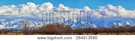 Winter Panoramic View Of Snow Capped Wasatch Front Rocky Mountains, Great Salt Lake Valley And Cloud