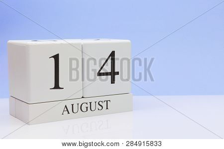 August 14st. Day 14 Of Month, Daily Calendar On White Table With Reflection, With Light Blue Backgro
