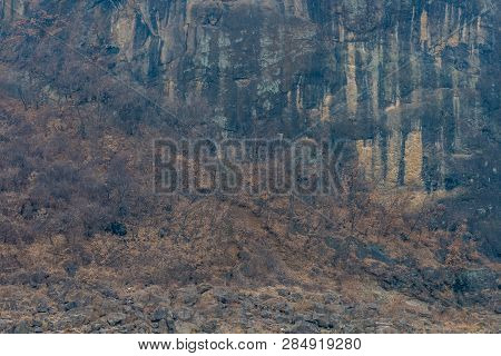 Closeup Of Jwasangbowi Rock, A Large Volcanic Rock In  Jangtan-ri, South Korea, In Background.