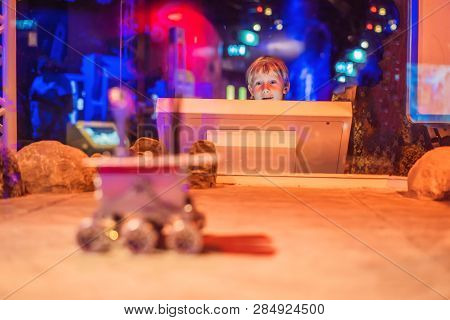 The Boy Controls The Toy Rover On Mars. Flight To Mars Concept