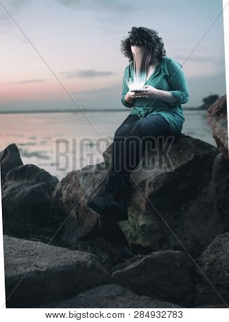 Woman Using Smartphone Outside. The Concept Of Phone Addiction. Face Absorbed By The Phone.