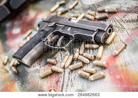 Top View Of Gun And Ammunition On The Table