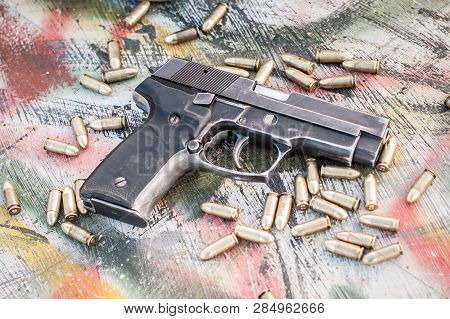 Top View Of Gun And Ammunition On The Table