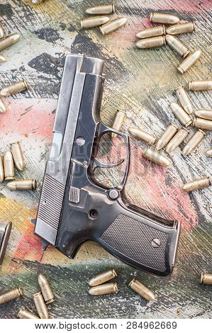 Top View Of Gun And Ammunition On The Table