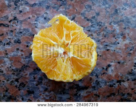 Juicy Biten Orange Head On Marble Windowsill