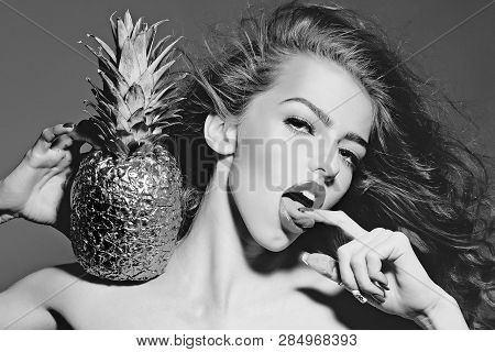 Sexy Woman With Finger In Sensual Mouth. Girl With Golden Pineapple Or Ananas. Beauty, Makeup, Look,