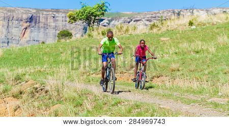 African Children Riding A Bike In Rural A Village