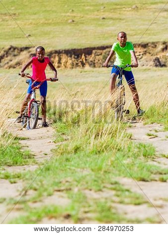 African Children Riding A Bike In Rural A Village