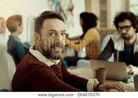 Smiling Man In A Brown Sweater Looking Contented