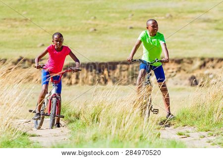 African Children Riding A Bike In Rural A Village